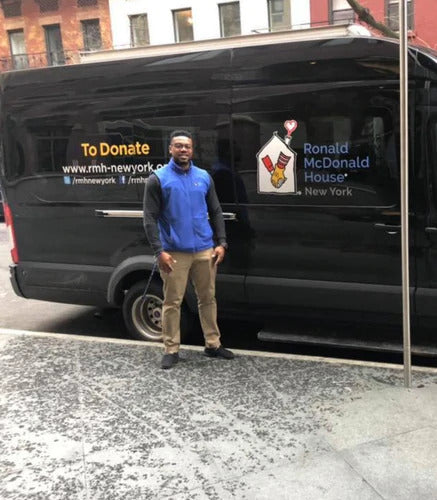 Odain in front of the transportations services van