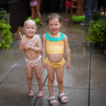 Ruby and Beatrix in the sprinklers at the Fourth off July celebration on the 3rde floor terrace