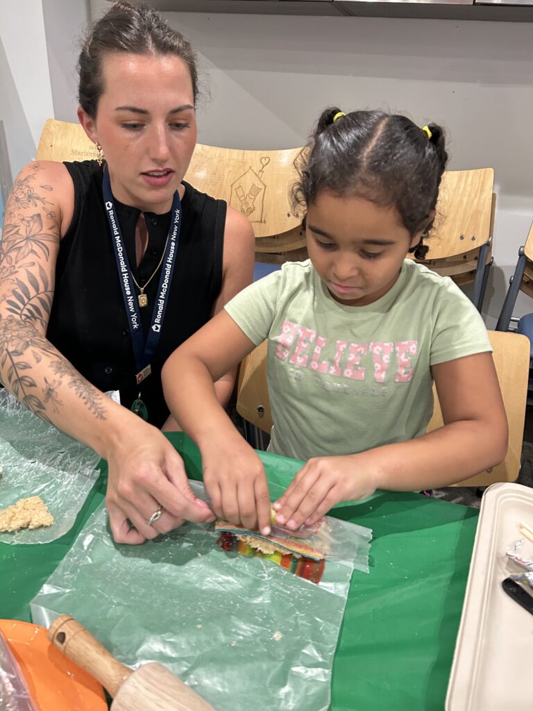 Chef Darby helping a child with crafts